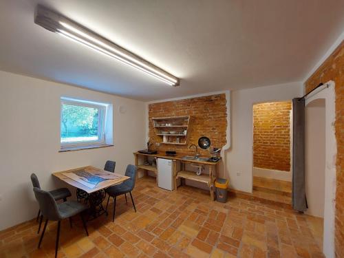 a room with a desk and a table and chairs at Villa Coola in Ljubljana