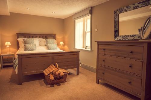 a bedroom with a bed with a dresser and a mirror at Acorn Apartment in York