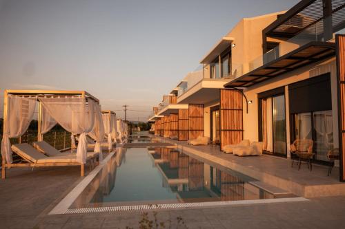 a swimming pool in front of a building at Salt Boutique Hotel in Palouki