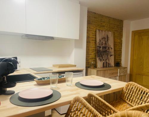 a kitchen with a wooden table with plates on it at Casa del palmar suite in Valencia