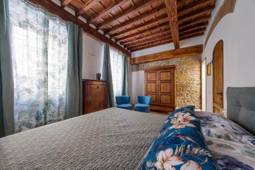 a bedroom with a bed and two blue chairs at Il Giardino Fiorentino - Luxury Apartment & Spa in Florence