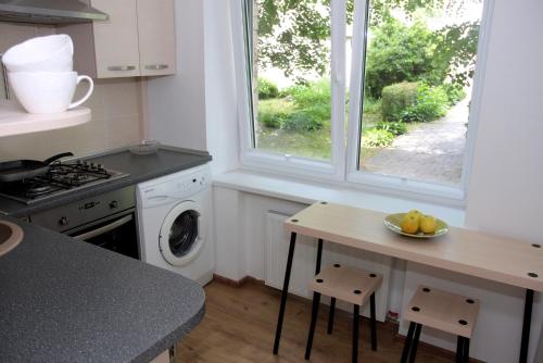 a kitchen with a table with a bowl of fruit on it at Apartment Danes 35 in Klaipėda