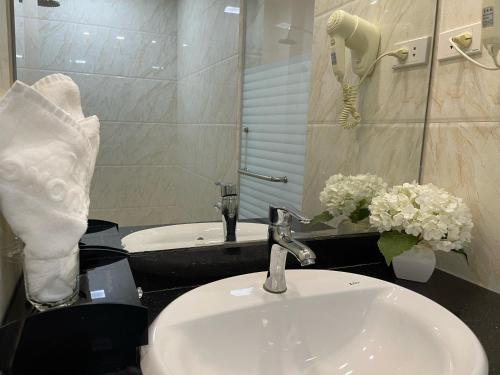 a bathroom with a sink and a phone on a counter at Hoa Phuong Hotel in Hai Phong