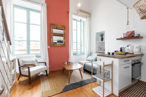 - une cuisine et un salon aux murs orange et blancs dans l'établissement Plage et Shopping ! Appartement au cœur de Nice !, à Nice