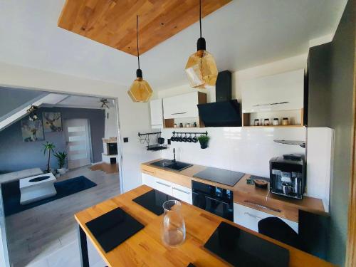 a kitchen with a wooden counter top in a room at Apartament 400 m od molo Międzyzdroje in Międzyzdroje
