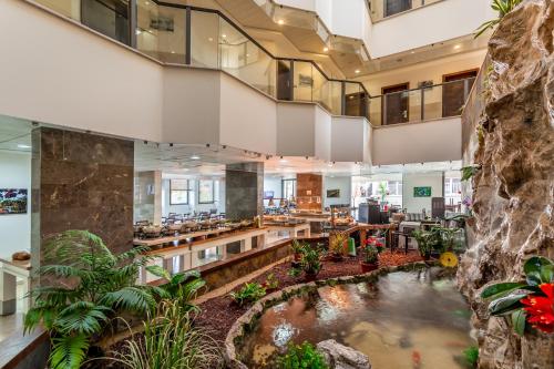 a hotel lobby with a koi pond at Emily's Hotel in Tiberias