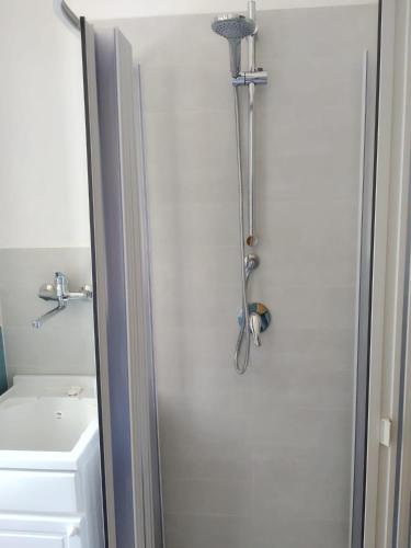 a shower in a bathroom with a toilet and a sink at Appartamenti vistAmare - La casa del vento in Vibonati