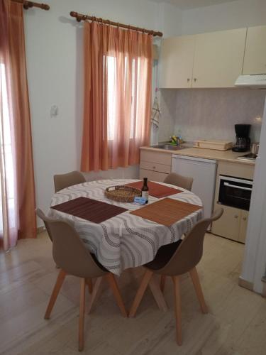 a kitchen with a table and chairs in a kitchen at Αrgo Studios in Pythagoreio