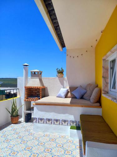 a bed sitting on the side of a balcony at The Sweet Lemon 3 in Bombarral
