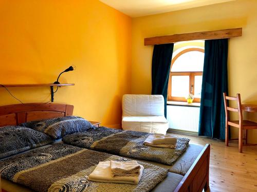 a bedroom with a bed and a window at Penzion Jiřičná in Jiřičná