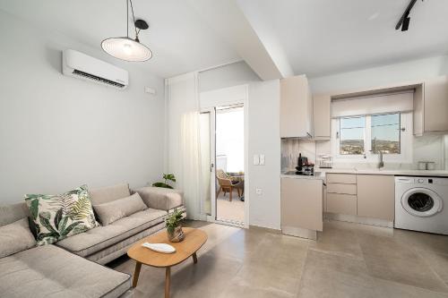 a living room with a couch and a table at Gifel Apartments and Luxurious Suites in Kalamaki Heraklion