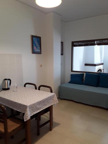 a living room with a table and a couch at Alex Central City Accommodation in Lávrion