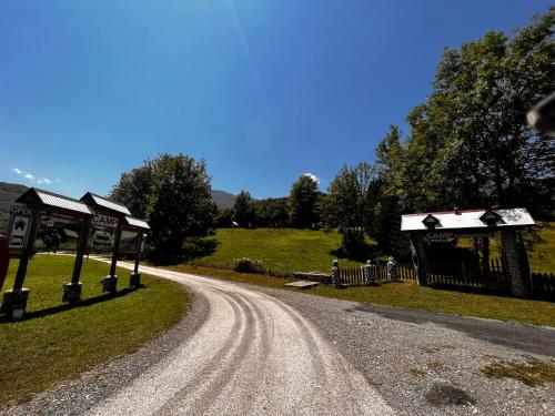 a dirt road next to a gas station on a hill at Tara Place - Camp Rabrenovic in Mojkovac