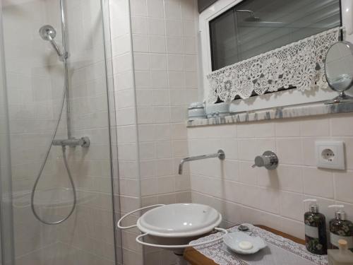 a bathroom with a shower with a toilet and a sink at Casa Manel d'Anita in Alge