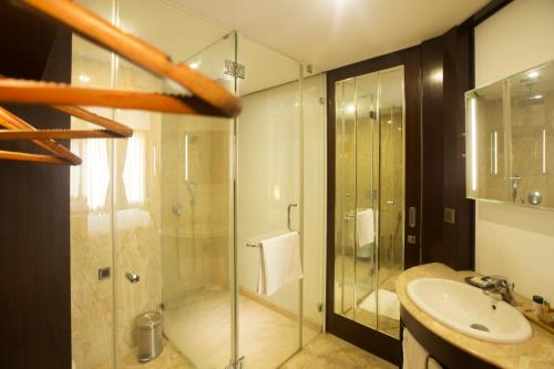 a bathroom with a glass shower and a sink at Sea Shell Coral Cove in Port Blair
