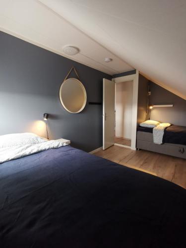a bedroom with a bed and a mirror on the wall at Andenes Sentrum Apartment in Andenes