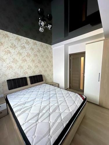 ein Schlafzimmer mit einem großen weißen Bett darin in der Unterkunft Nico Apartment in Mamaia Nord – Năvodari