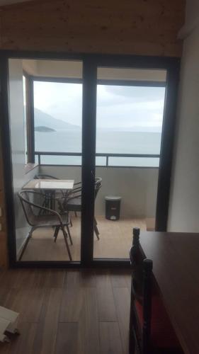 a room with a table and a view of the ocean at Villa Malezan in Ohrid