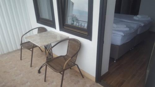 a table and two chairs in a room with a bed at Villa Malezan in Ohrid