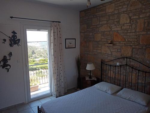a bedroom with a bed and a stone wall at Traditional art apartment 3 in Akoumia