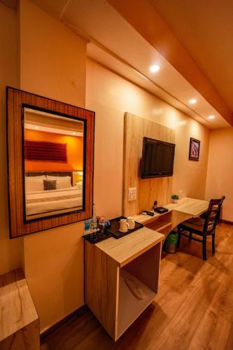 a bathroom with a sink and a mirror at Hotel 360 by D'Polo Dharamshala in Dharmsala