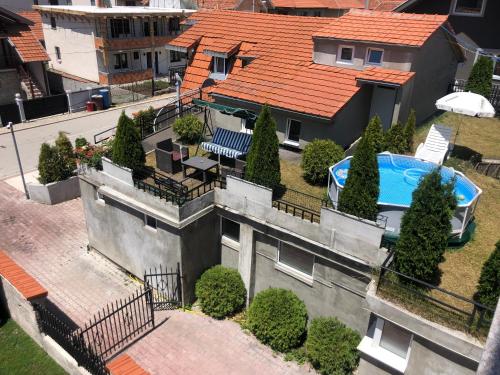 an aerial view of a house with a swimming pool at APARTMANI & RESTORAN -S O K O- SJENICA in Sjenica