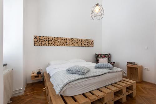 ein Schlafzimmer mit einem Bett auf einer hölzernen Plattform in der Unterkunft Second Home Apartment by Loft in Ljubljana