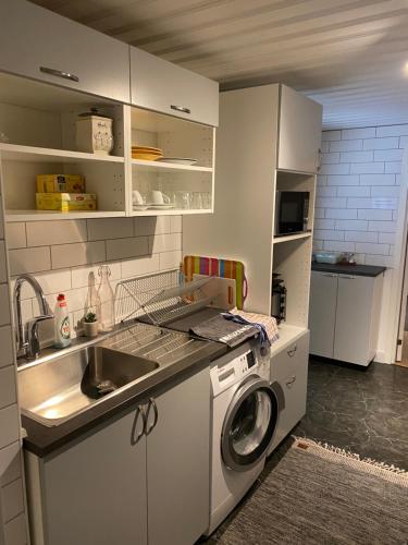 a kitchen with a sink and a washing machine at Karlskrona in Rödeby
