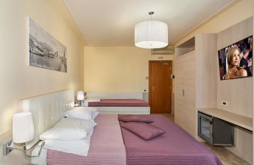 Ένα ή περισσότερα κρεβάτια σε δωμάτιο στο Hotel Bella Riviera Lungomare