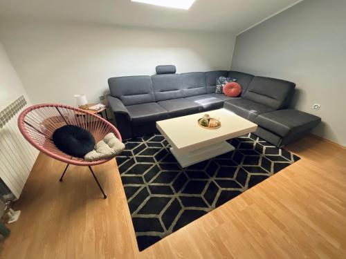 a living room with a couch and a table at Apartment Camellia in Ljubuški