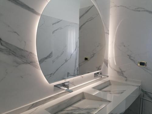 a bathroom with a sink and a mirror at Civico57 Torre Suda in Torre Suda