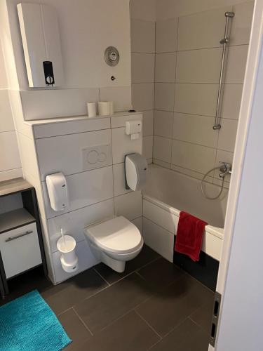 a small bathroom with a toilet and a shower at Waffel Cafe HOSTEL Monteurwohnung Ferienwohnung in Kassel