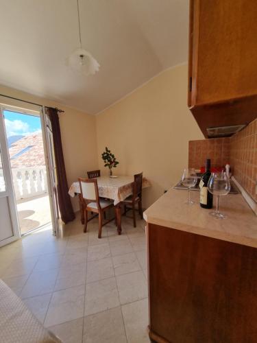 a kitchen and dining room with a table with a view at Lovely apartment Jovan 3,with a view of the bay and free Wi-Fi in Kotor