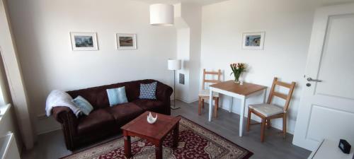 a living room with a couch and a table at FeWo Lieblingshof in Lieblingshof