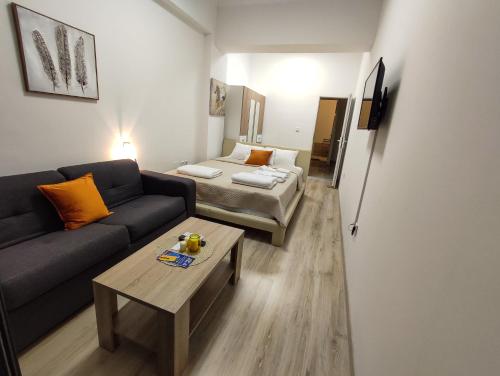 a living room with a couch and a table at Sole Mio Apartment & Wellness in Herceg-Novi