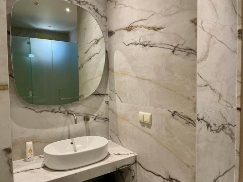a bathroom with a sink and a mirror at Byblos Aria-The Sea Side Luxury Villa in Skala Sotiros