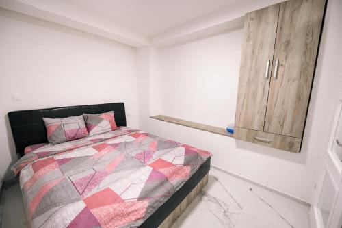 a bedroom with a bed and a wooden cabinet at Down Street-Old Town in Ohrid