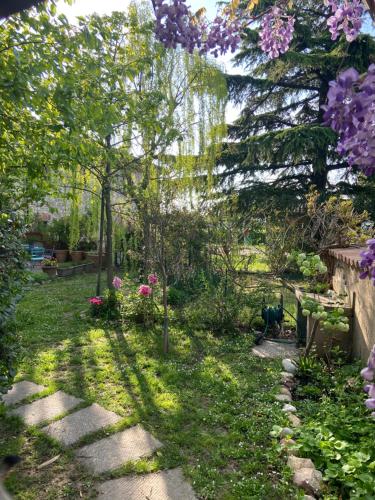 a garden with some trees and a path at Monte Maino Bed & Breakfast in Desenzano del Garda