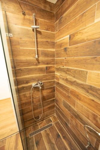 a shower with wooden walls and a wooden floor at Down Street-Old Town in Ohrid