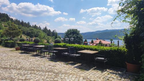a row of tables and chairs on a brick patio at Glavatarski Han in Glavatartsi