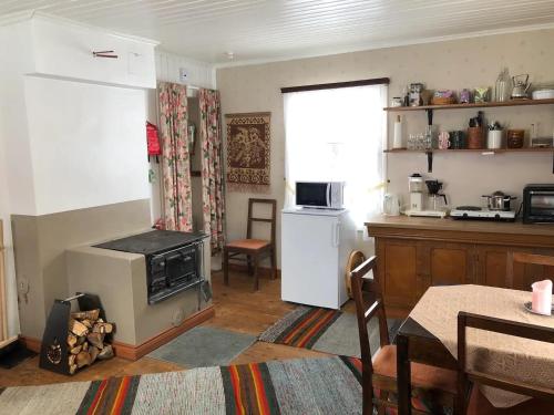 a kitchen with a stove and a table in a room at Abbis lillstuga 