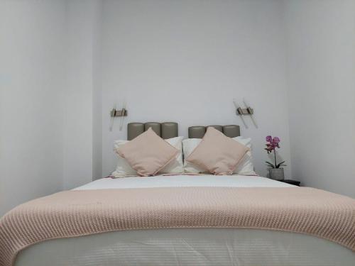 a bedroom with a large bed with pink pillows at charming loft in Porto in Porto