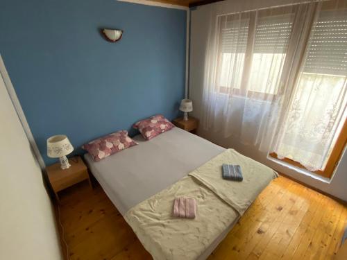 a bedroom with a bed with two pillows on it at Apartment Cuni in Mostar