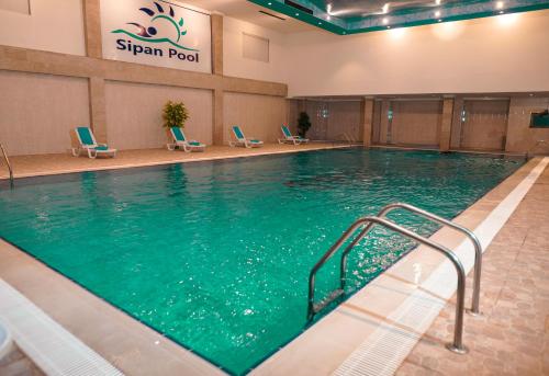 a large swimming pool in a hotel room at Sipan Hotel in Erbil