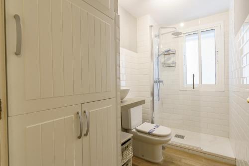 a white bathroom with a toilet and a shower at CT 178 - Versalles City Apartment - Fuengirola in Fuengirola