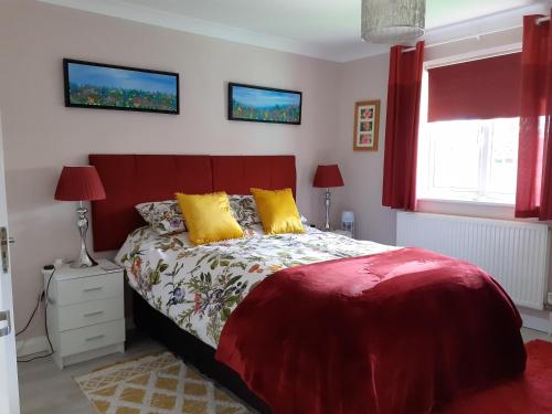 a bedroom with a large bed with yellow pillows at Safe haven in Peacehaven