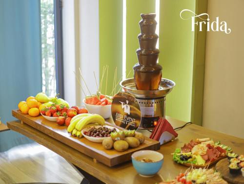 a wooden table with a tray of fruits and vegetables at Hotel & Restaurant Frida in Gjakove