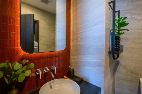 a bathroom with a sink and a mirror at EDGE Central pattaya near walking street in Pattaya Central