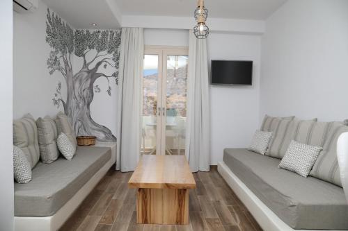 a living room with two couches and a coffee table at GRΕΛΙΑ ΗΟΜΕ in Naxos Chora