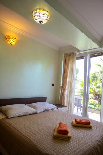 a bedroom with a bed with two towels on it at Apartments Okuka in Split